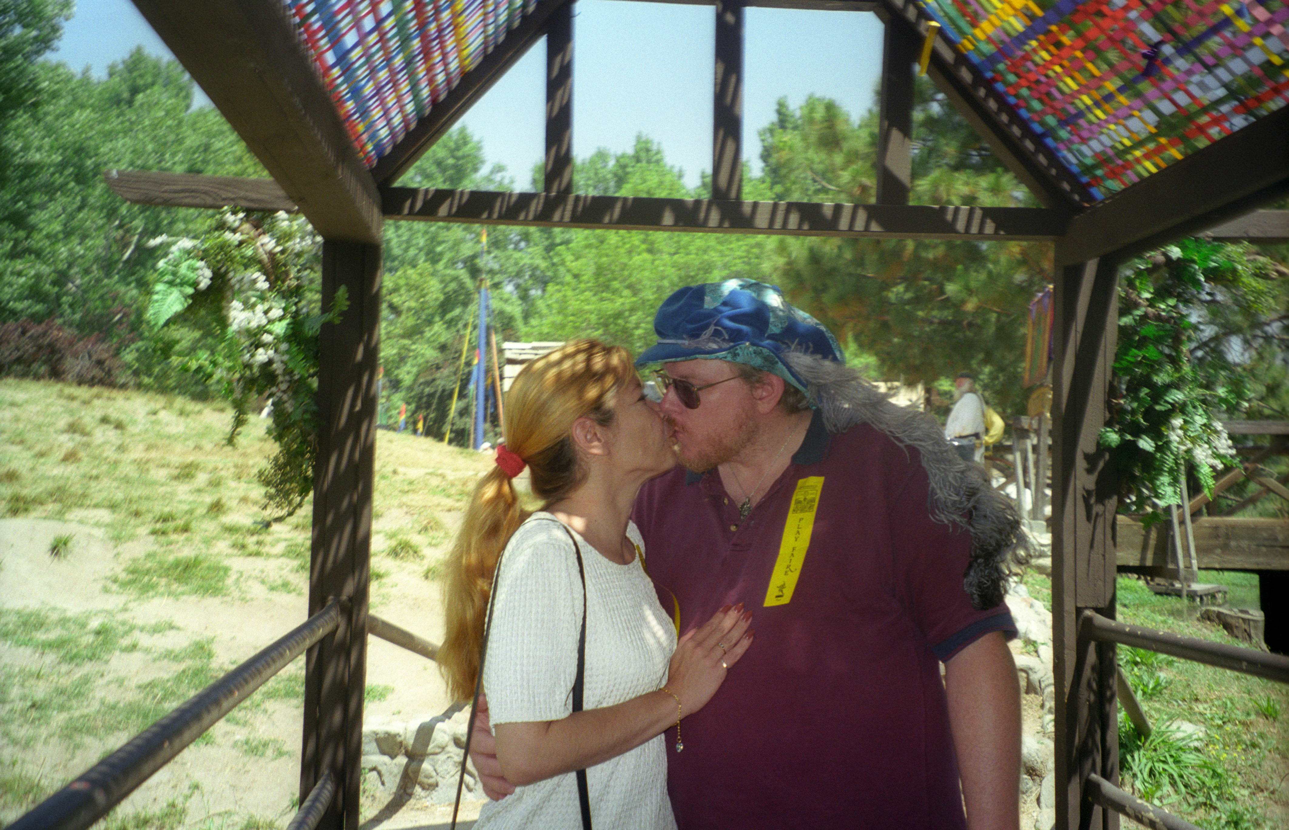 Richard and Claudia Lowe kissing at the Renaissance Faire in Devore, California, before her illness