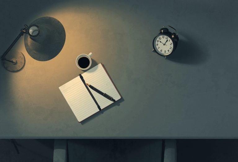 A ghostwriter and author on a video call, one person speaking while the other listens attentively at their desk. TITLE