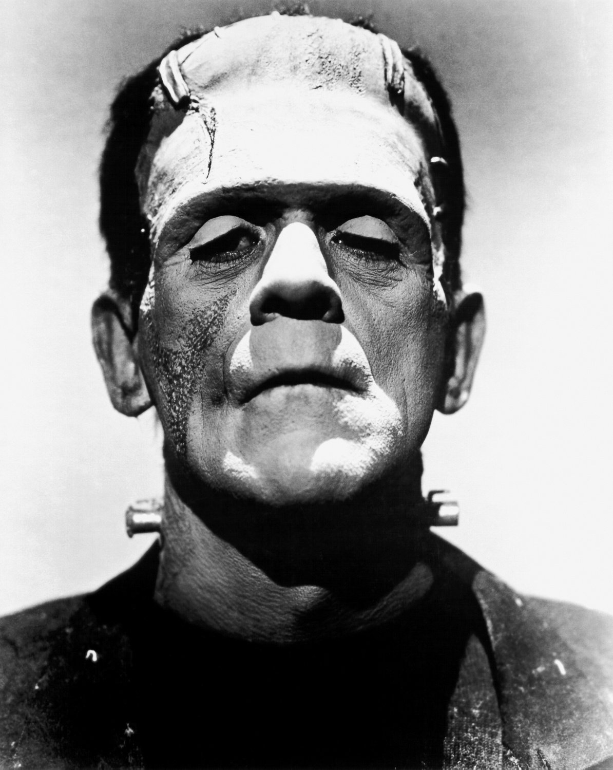 Boris Karloff as Frankenstein's monster in a 1935 publicity portrait, with the flat-topped head, forehead scars and neck electrodes